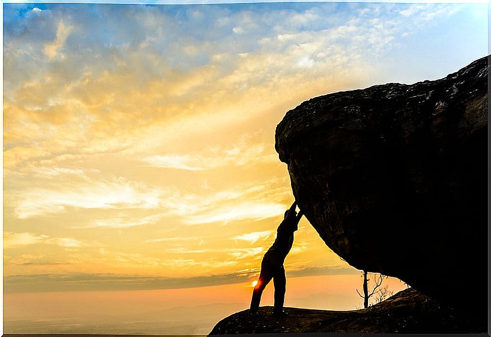 Man pushing a rock