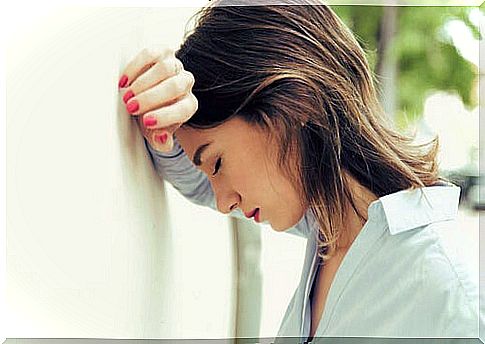 Woman leaning on the wall trying to have self-control