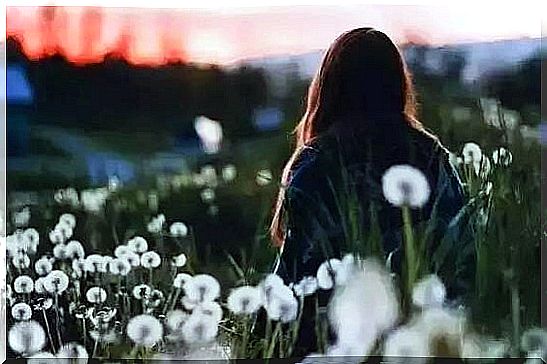 Girl surrounded by dandelions