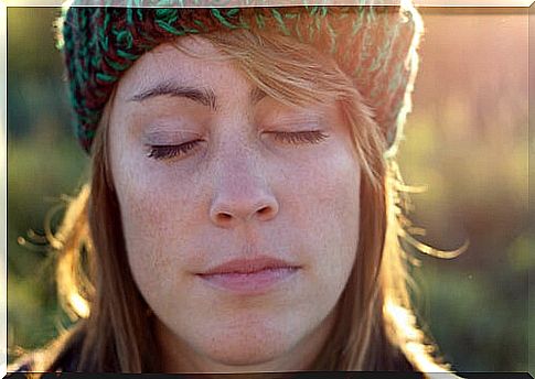 Woman with eyes closed performing raisin exercise