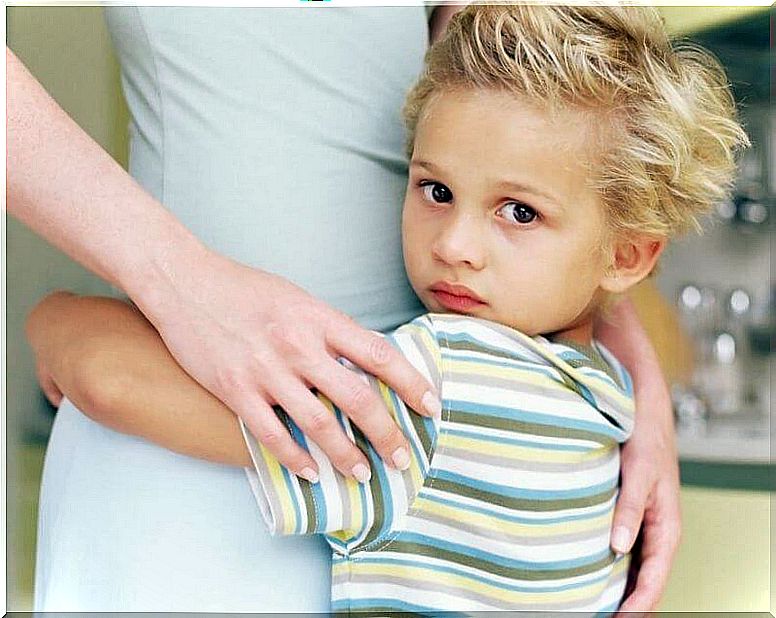 Child clutching his mother representing the effect of emotionally unavailable parents