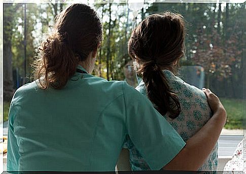 Nurse hugging a woman and working on cancer communication