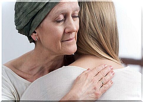 Woman with cancer hugging her daughter