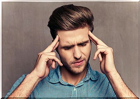 Man with Hands on Head Trying to Practice Focusing