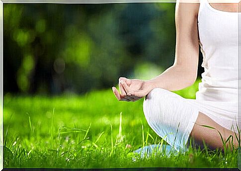 Woman meditating on grass