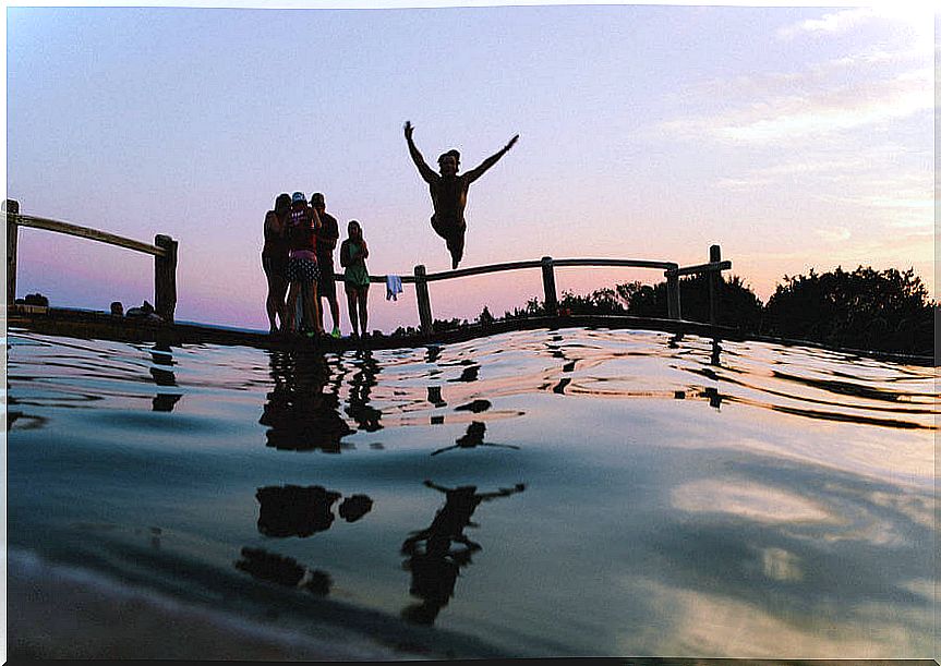 Friends in a pool at sunrise