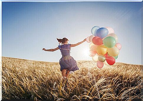 Woman with balloons happy and showing emotional intelligence