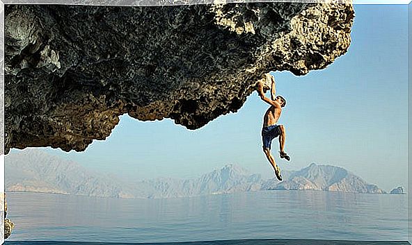 boy climbing and feeling the adrenaline of leaving everything for the last moment