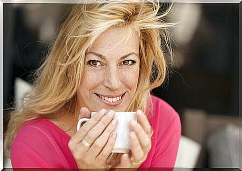 Forty woman drinking coffee symbolizing how to be happier after middle age