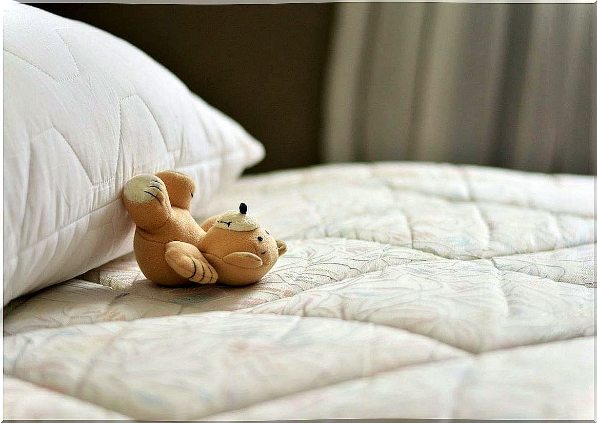 Bed with teddy bear symbolizing people without free time