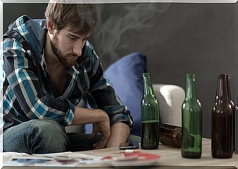 Young boy with bottles of alcohol on table