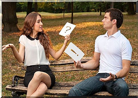 Couple sitting on a bench not understanding each other due to communication problems