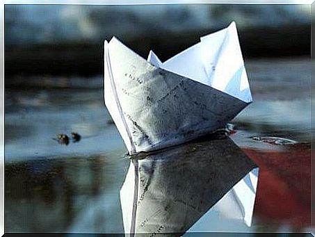 Paper boat in the water symbolizing therapy