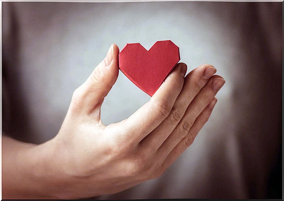 Paper heart in hand representing love