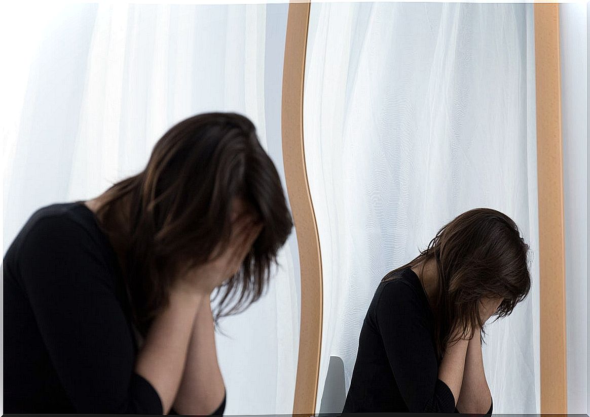 Crying woman in front of the mirror